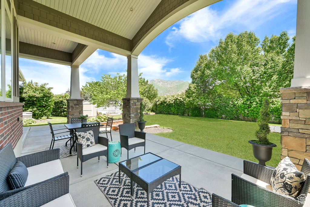 View of patio / terrace featuring an outdoor hangout area, a mountain view, and outdoor dining area