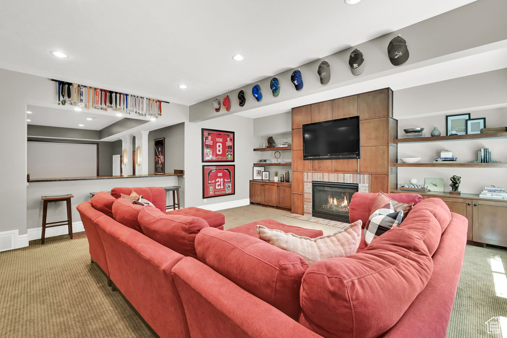 Living room featuring light carpet, recessed lighting, a fireplace, and baseboards
