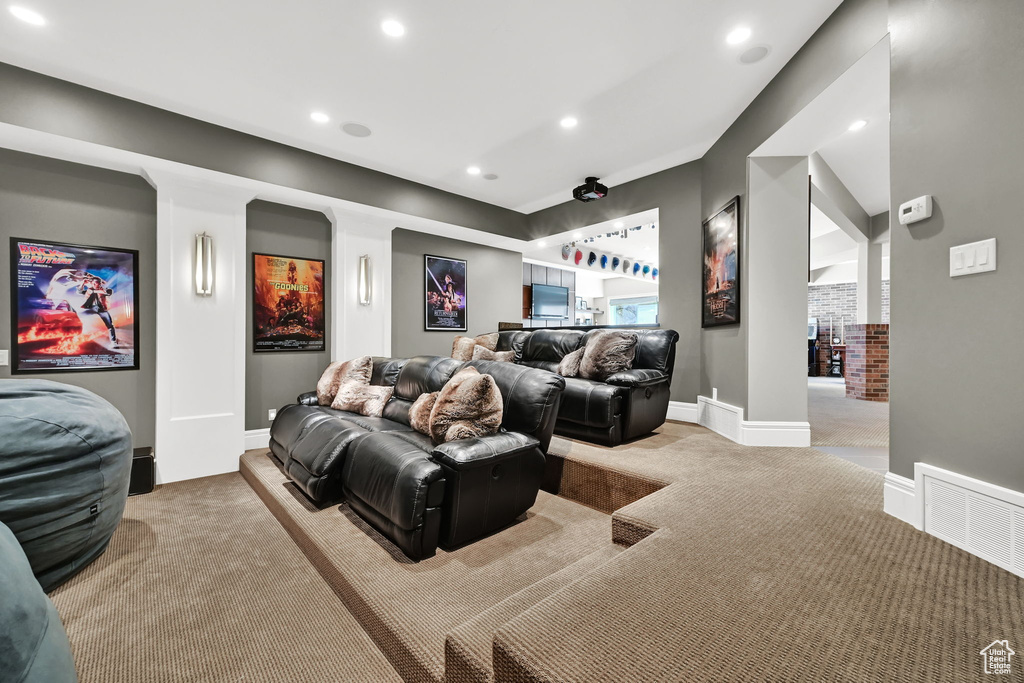 Home theater room featuring light colored carpet, recessed lighting, and baseboards