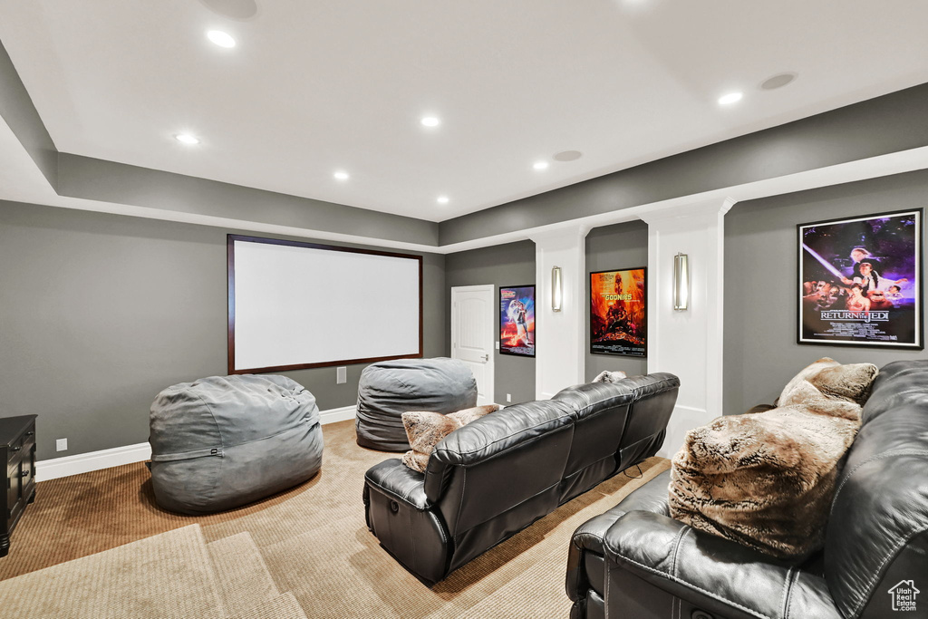Carpeted cinema room with recessed lighting and baseboards