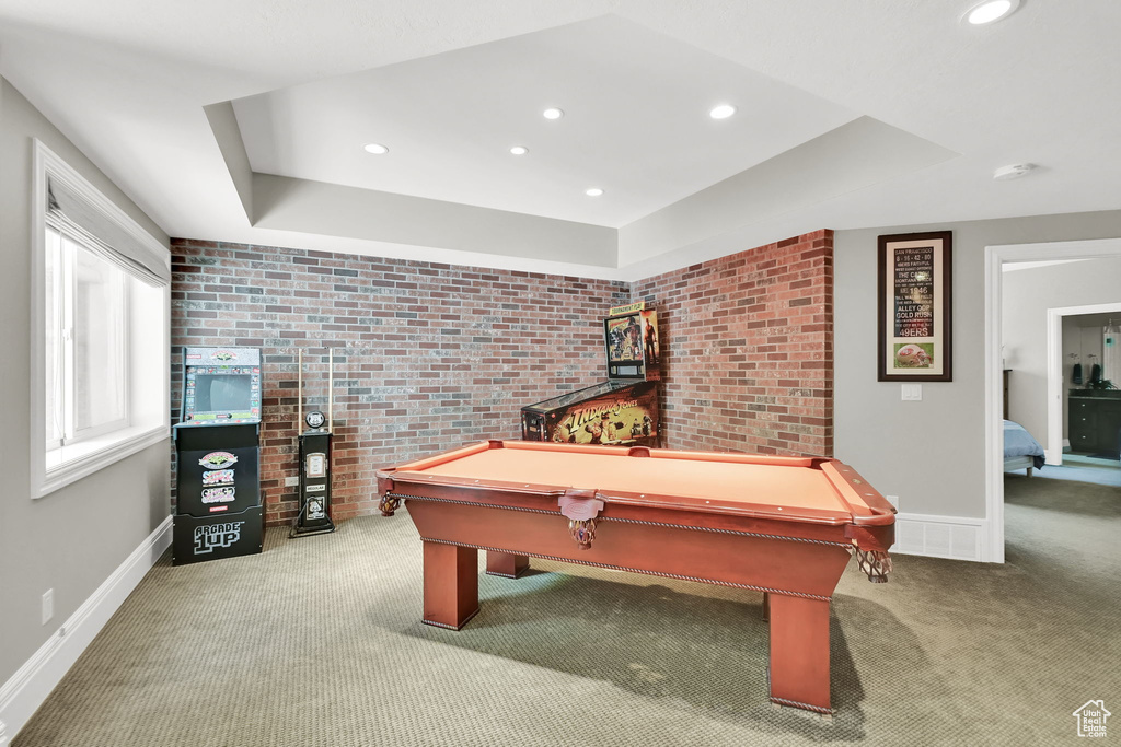 Recreation room with carpet floors, baseboards, pool table, recessed lighting, and brick wall