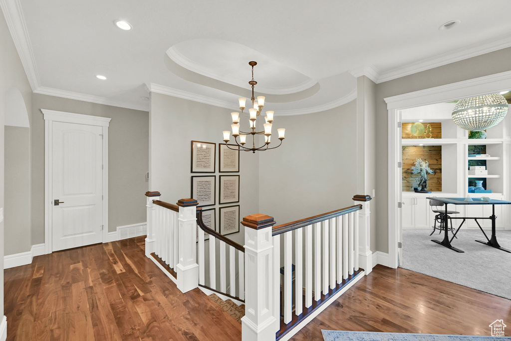 Corridor featuring an upstairs landing, a chandelier, dark wood-style floors, crown molding, and recessed lighting