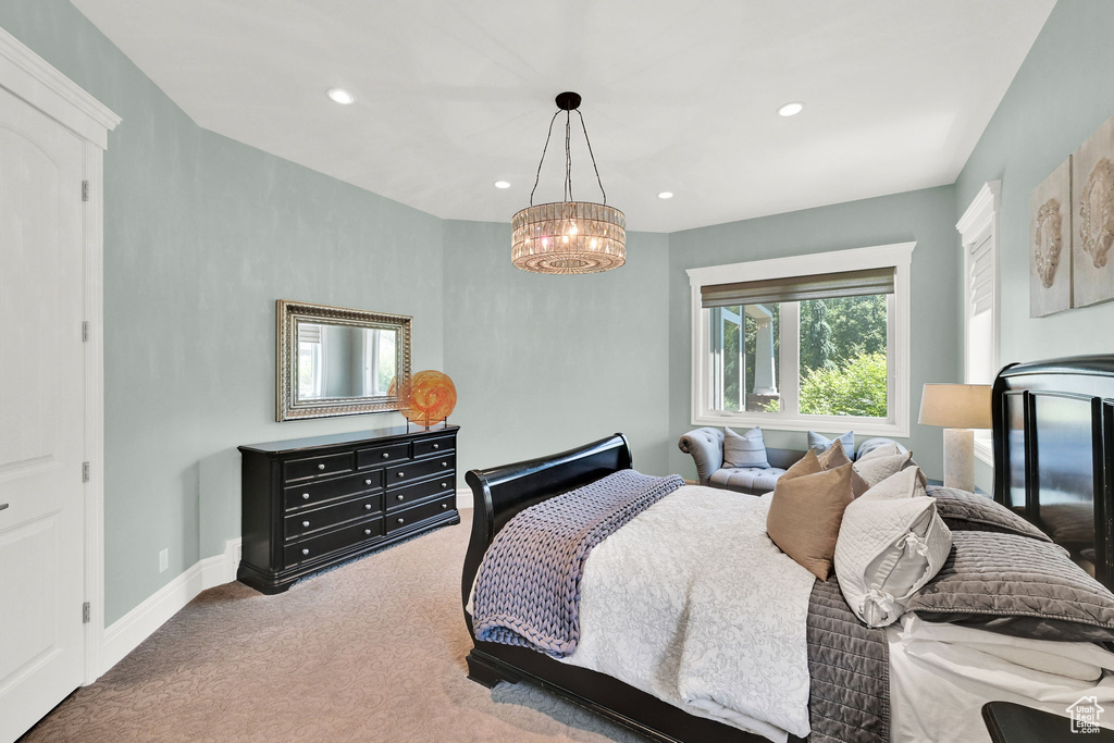 Carpeted bedroom featuring a chandelier, recessed lighting, and baseboards