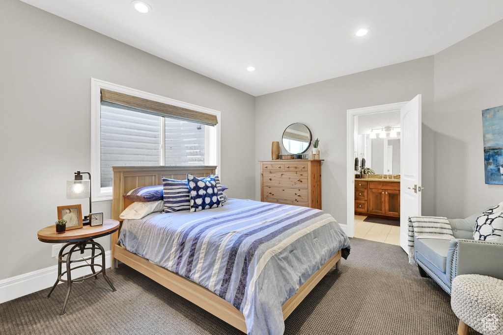 Bedroom featuring recessed lighting, baseboards, and ensuite bathroom
