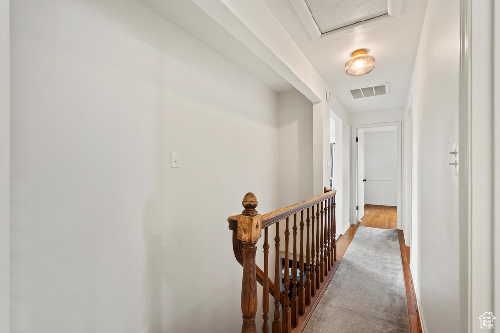 Hall with an upstairs landing and baseboards