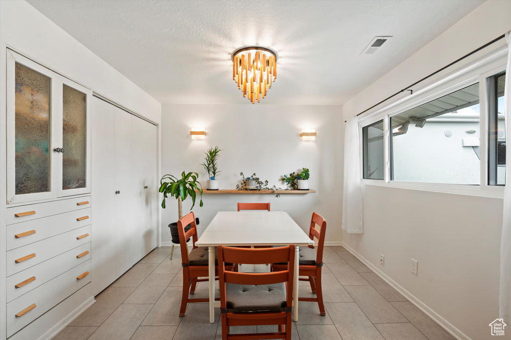 Dining room with light tile patterned floors and baseboards