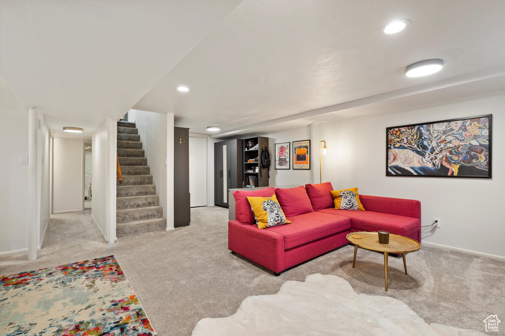 Living room with carpet flooring, stairway, baseboards, and recessed lighting