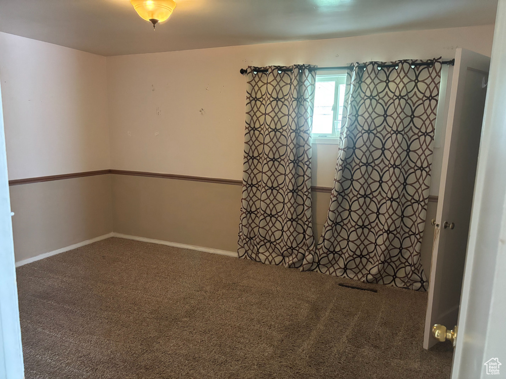 Unfurnished room with carpet and baseboards