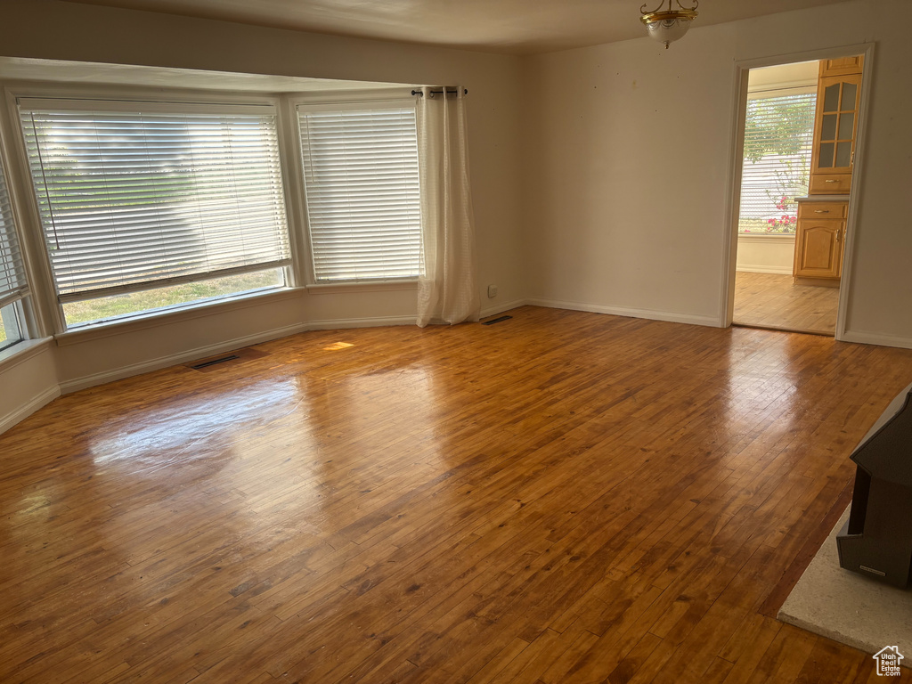 Spare room featuring baseboards and wood finished floors