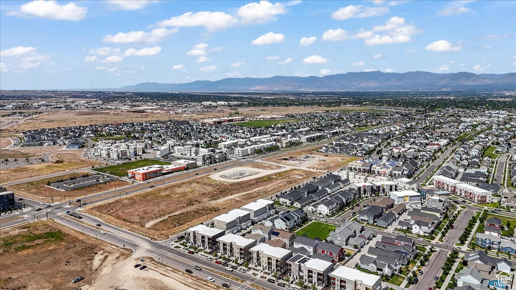 Aerial overview of property\'s location featuring a mountain backdrop and nearby suburban area