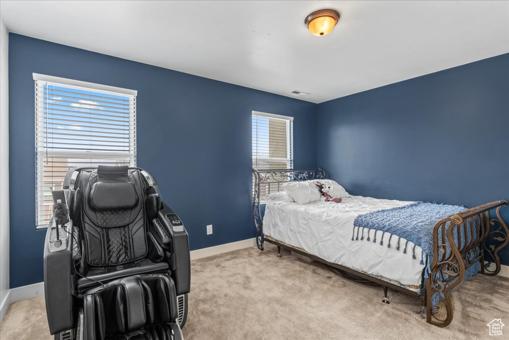 Carpeted bedroom featuring baseboards