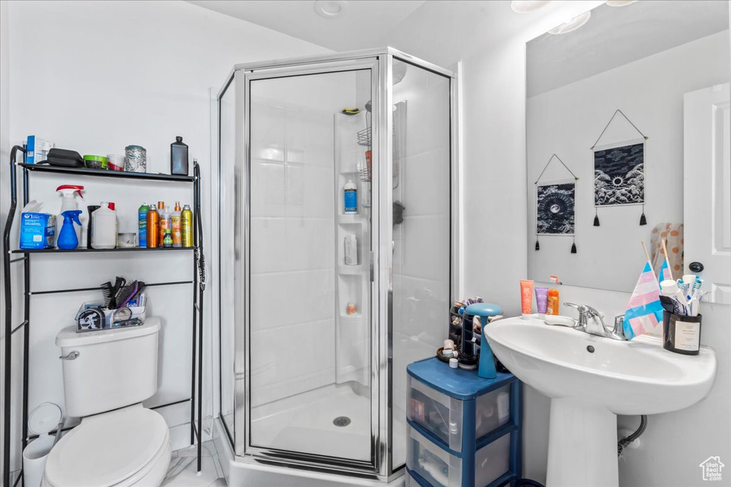Full bath featuring a shower stall and toilet