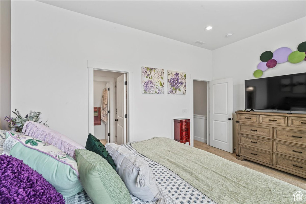Bedroom featuring light colored carpet