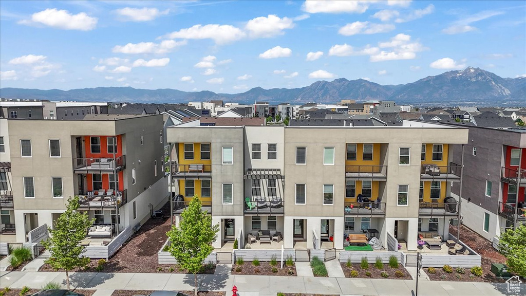 View of building exterior featuring a mountain view and a residential view