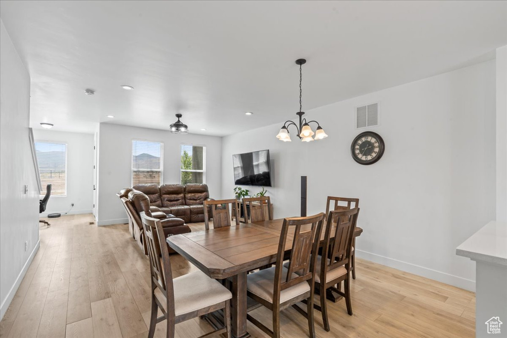 Dining area with light wood-style flooring, baseboards, and recessed lighting