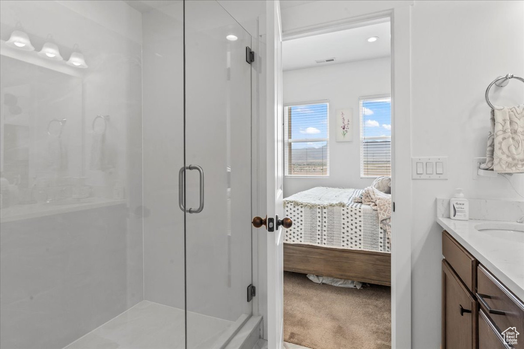 Full bathroom with connected bathroom, a shower stall, and vanity