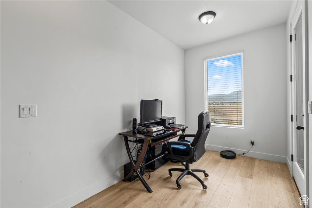 Office area with baseboards and wood finished floors