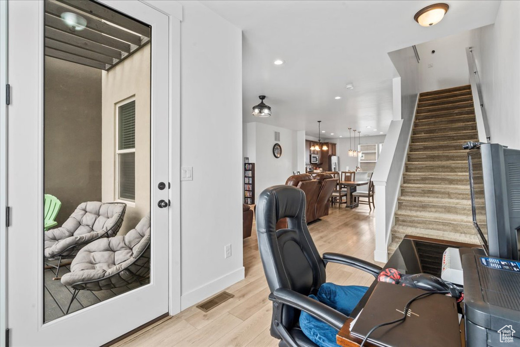 Office with light wood-style flooring, recessed lighting, and baseboards