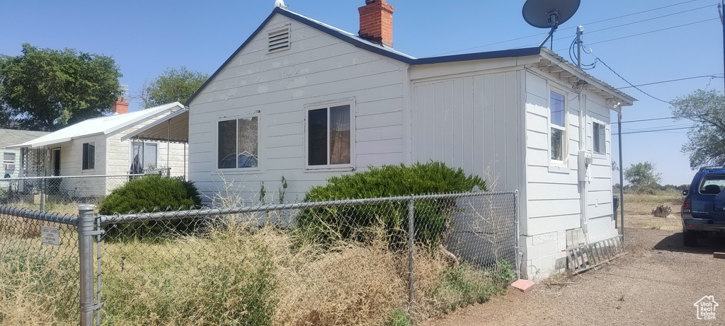 View of side of property featuring a chimney