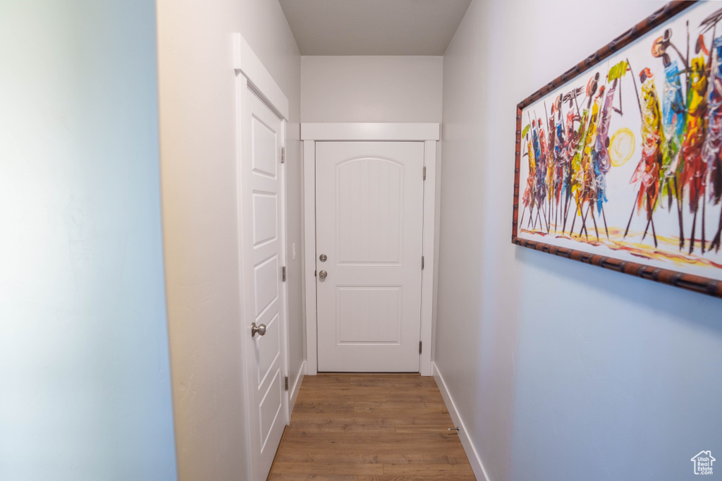 Hall with wood finished floors and baseboards