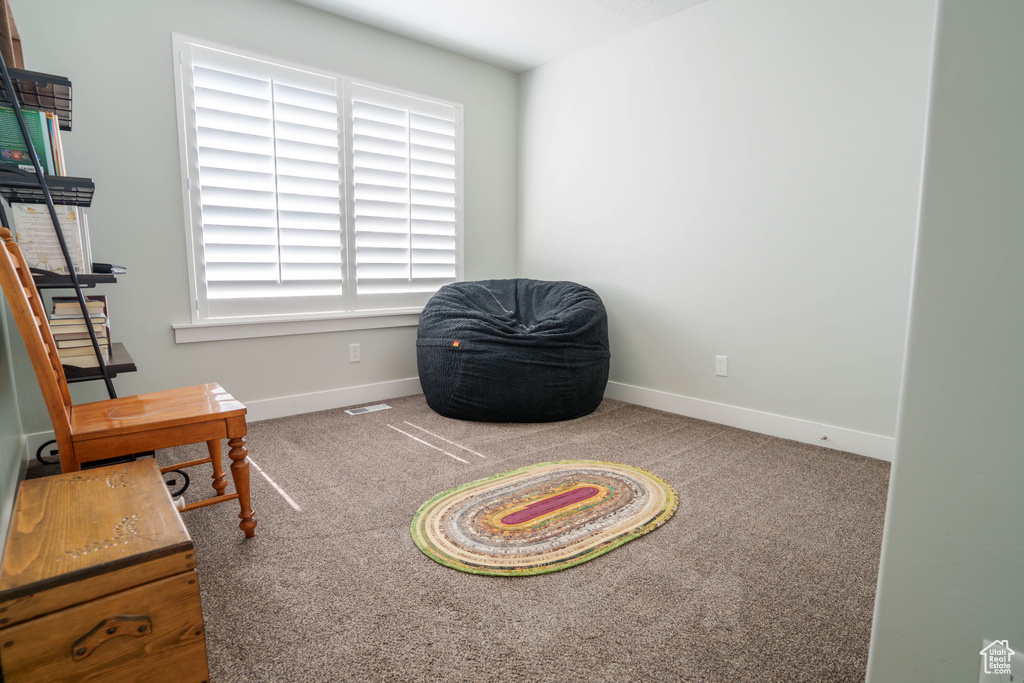 Sitting room with baseboards and carpet