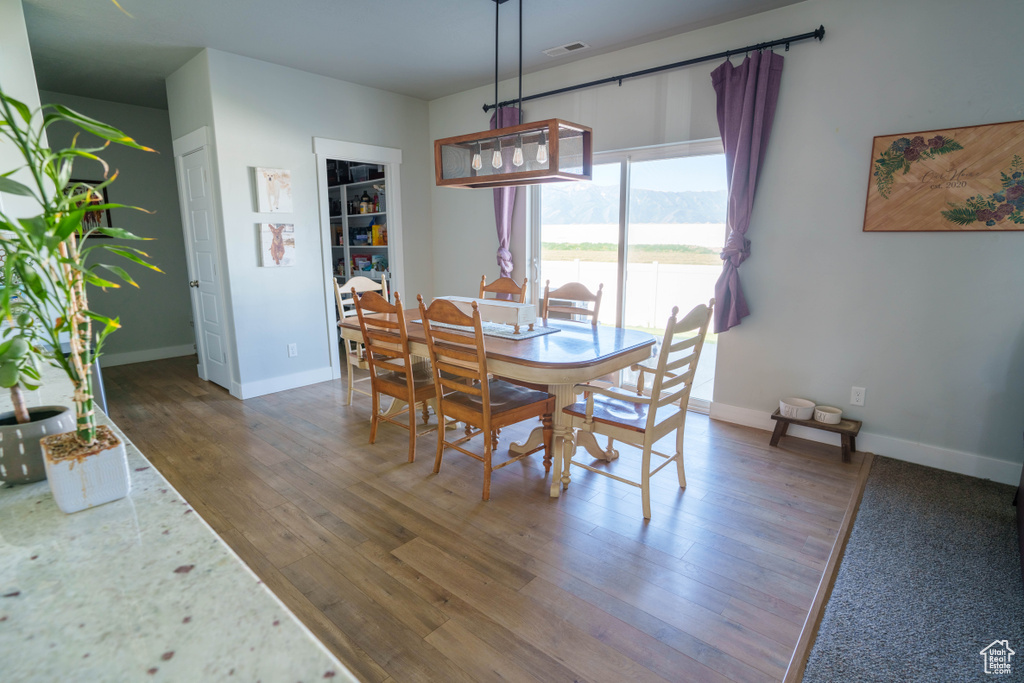 Dining area with wood finished floors, baseboards, and a mountain view