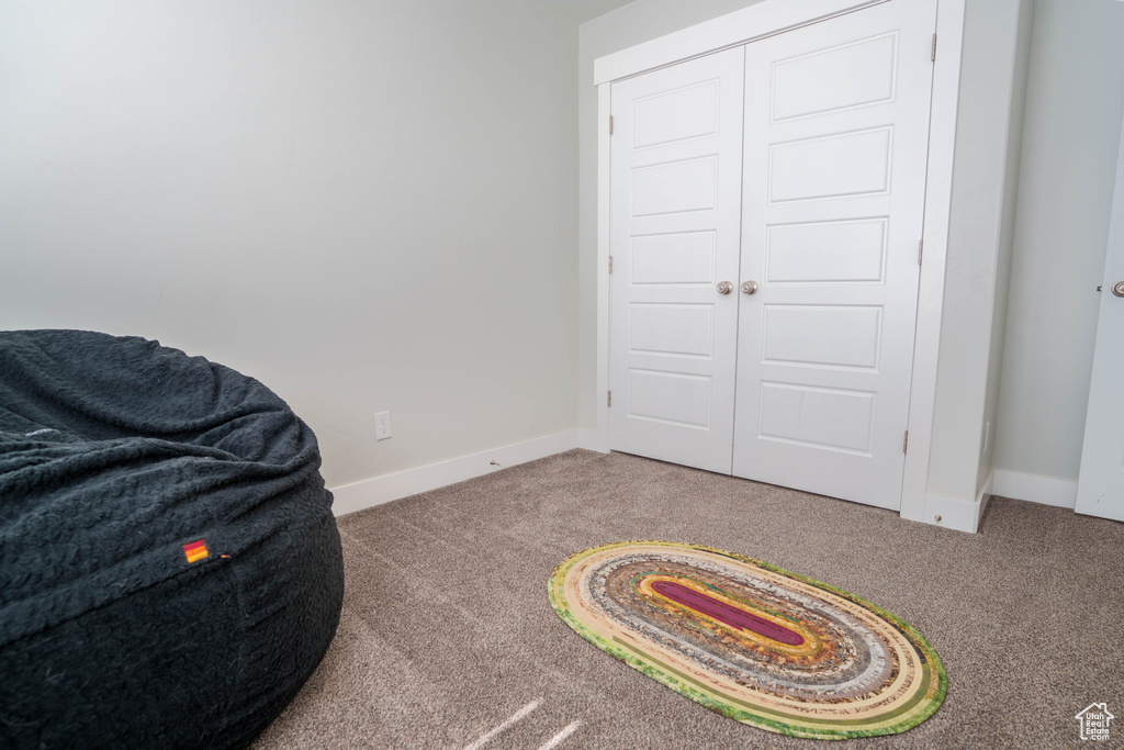 Living area with carpet floors and baseboards