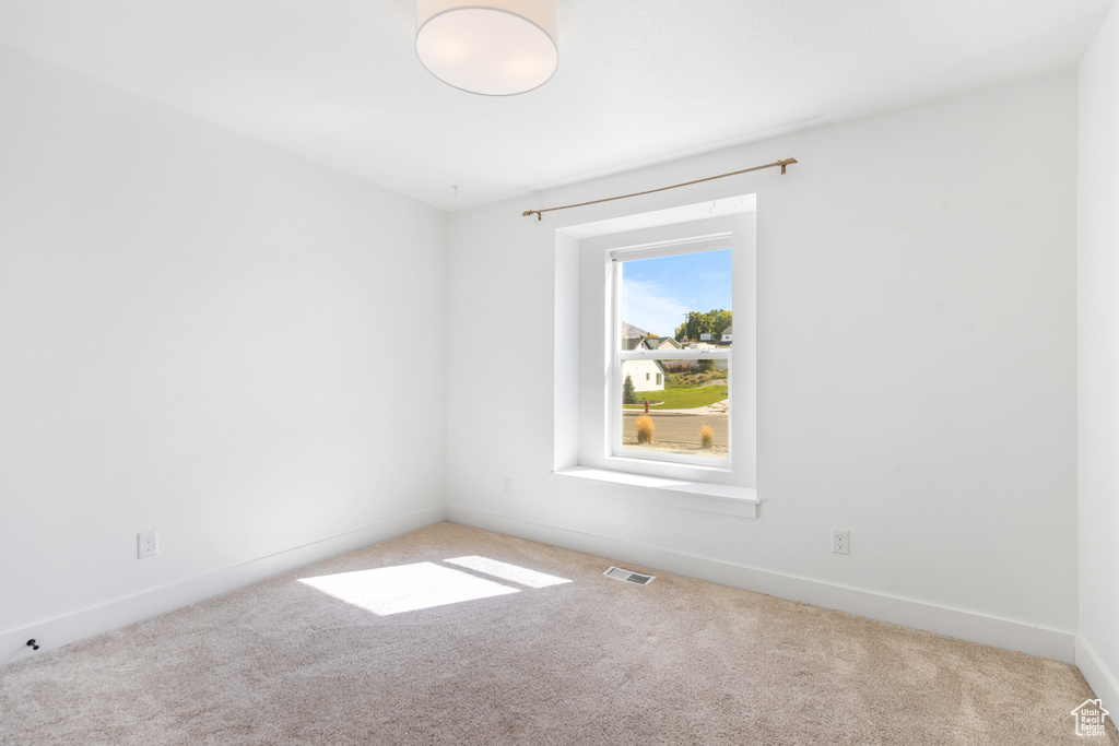 Empty room featuring carpet floors and baseboards
