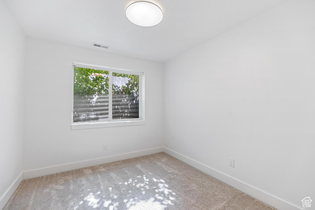 Empty room featuring carpet floors and baseboards