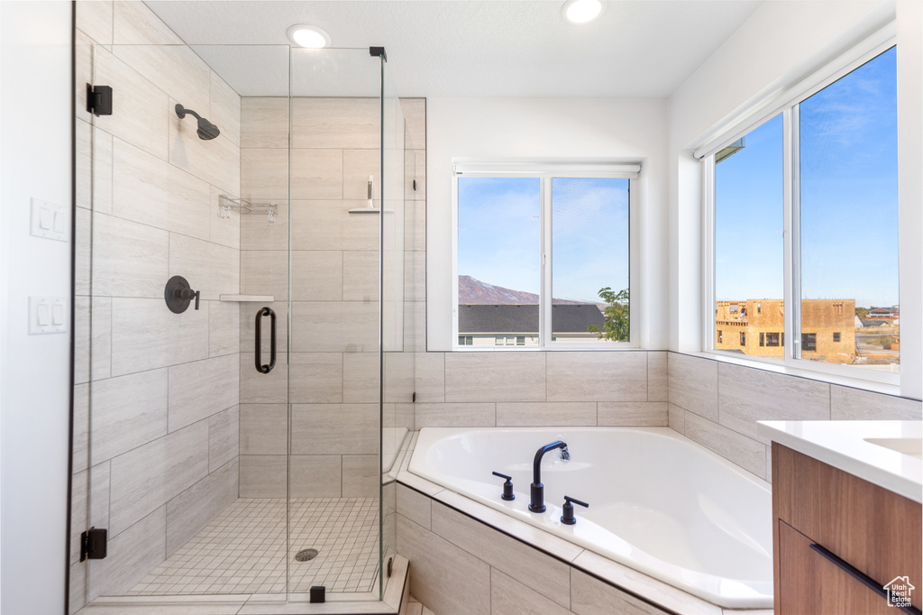 Full bathroom with a garden tub, a stall shower, vanity, and recessed lighting
