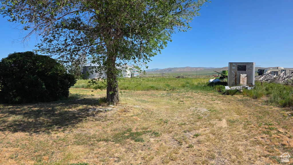 View of yard with a mountain view and a rural view