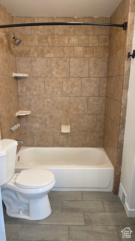 Full bathroom with toilet and bathing tub / shower combination