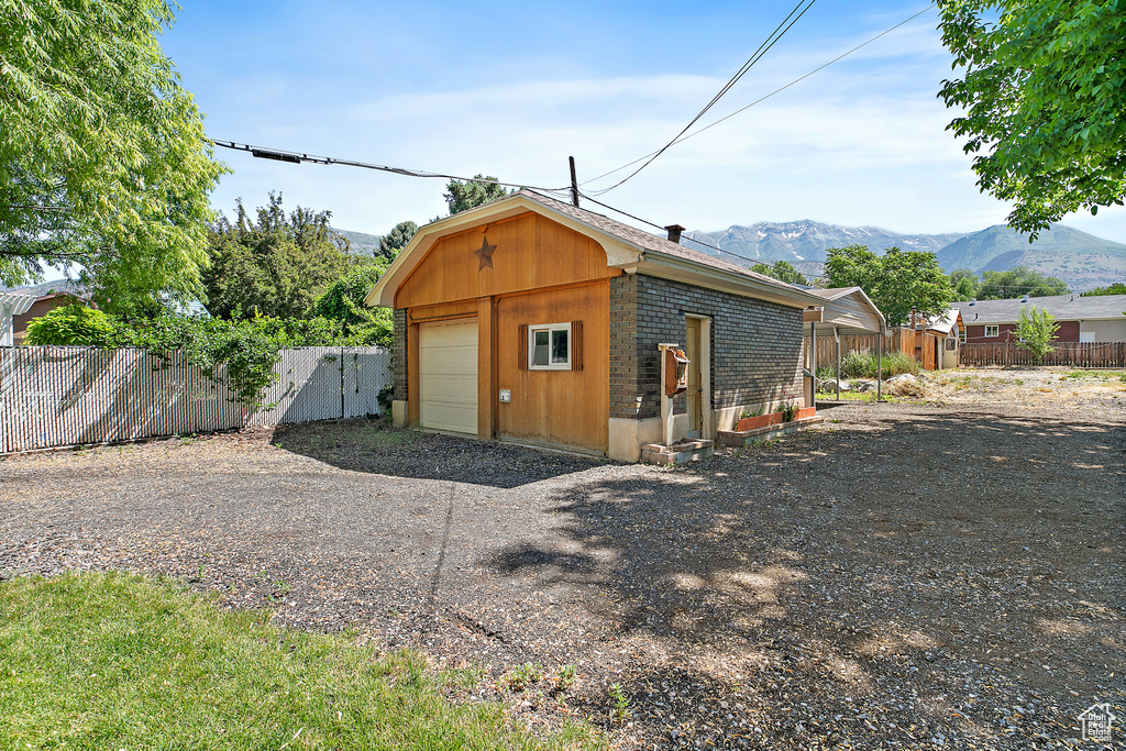 View of outbuilding with a mountain view and driveway
