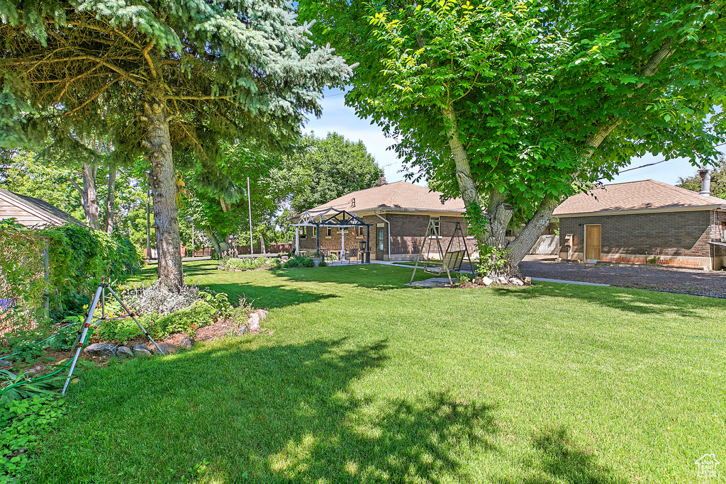 View of grassy yard with a gazebo