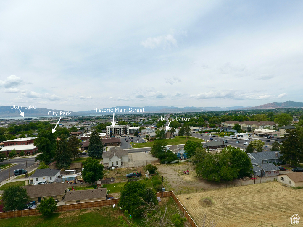 Aerial view of property\'s location with a mountain backdrop and nearby suburban area