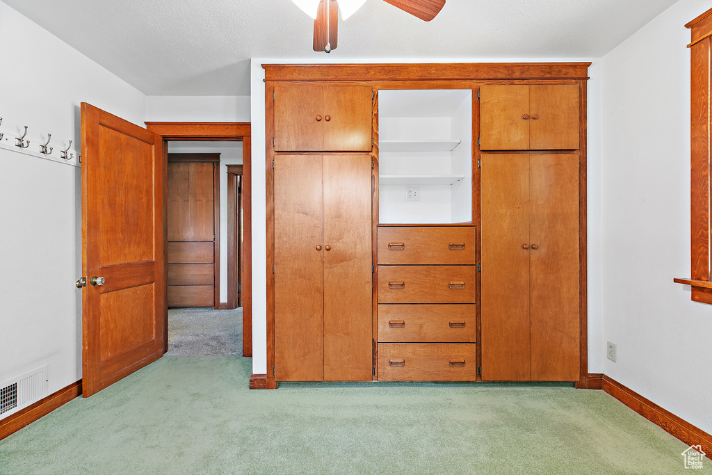 Unfurnished bedroom with carpet floors, baseboards, and a ceiling fan