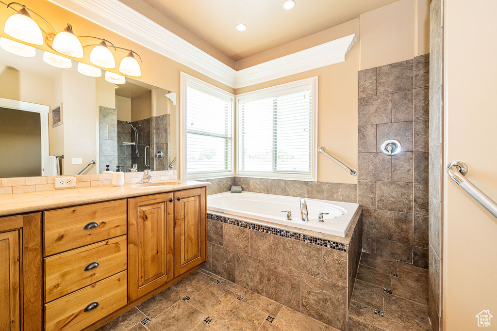 Full bath featuring vanity, walk in shower, a bath, recessed lighting, and tile patterned floors