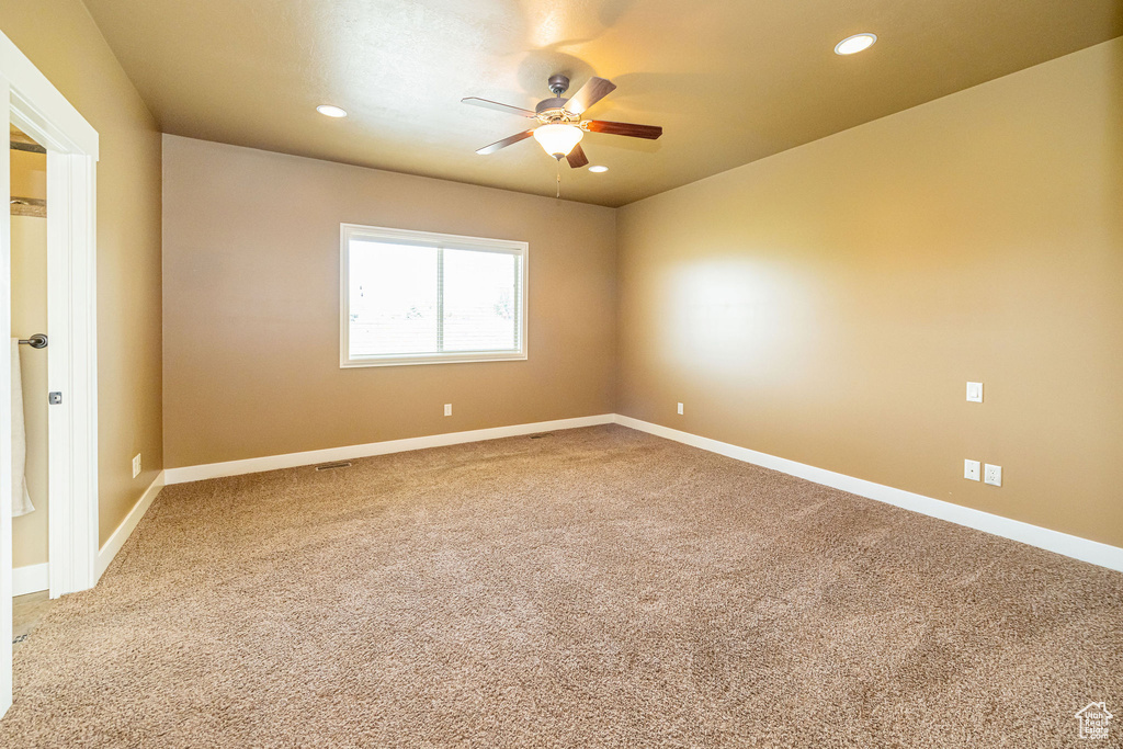 Empty room featuring ceiling fan, recessed lighting, carpet, and baseboards