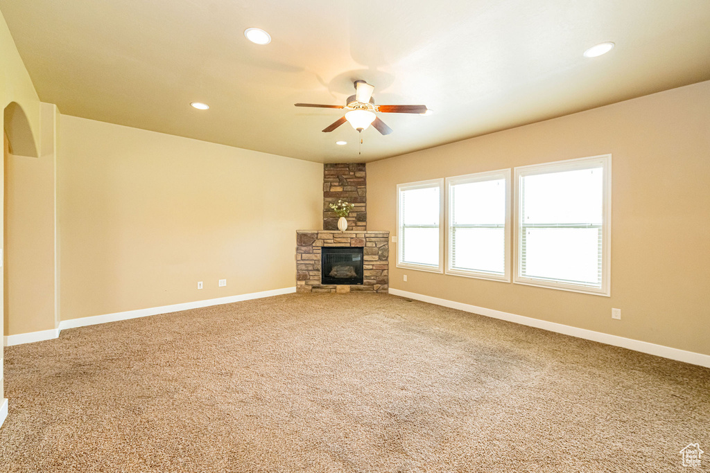 Unfurnished living room with a ceiling fan, carpet flooring, a fireplace, recessed lighting, and baseboards