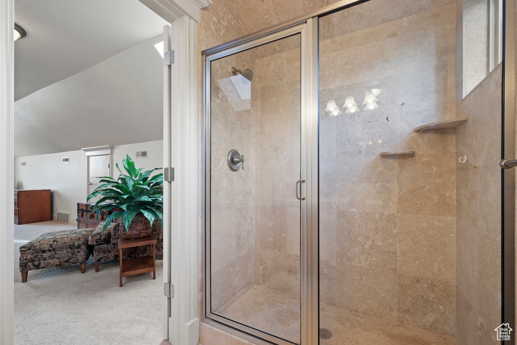 Ensuite bathroom featuring a stall shower