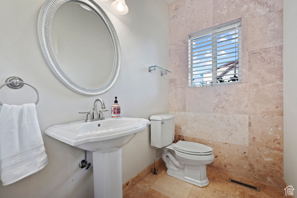 Bathroom with toilet and baseboards
