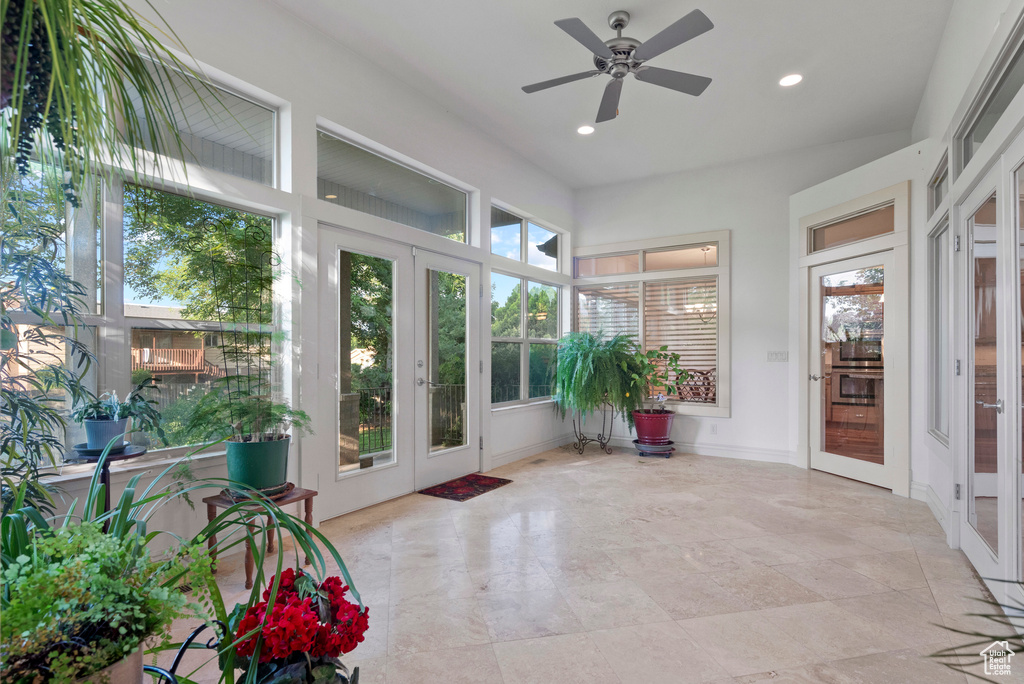 Unfurnished sunroom featuring french doors, plenty of natural light, and recessed lighting