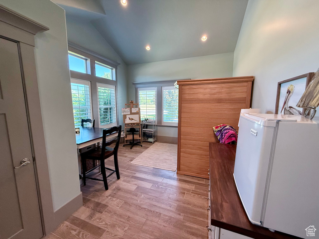 Office with light wood-style floors, high vaulted ceiling, recessed lighting, and baseboards