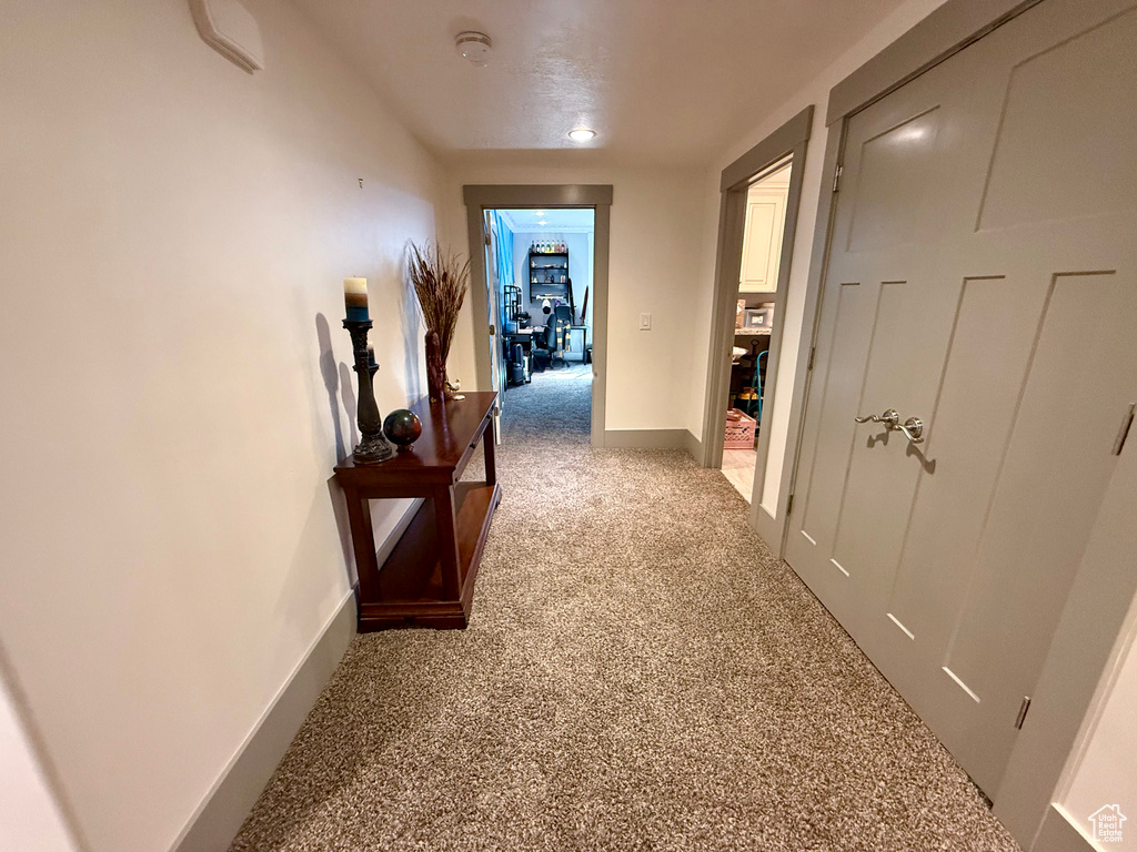 Hall featuring baseboards and carpet floors