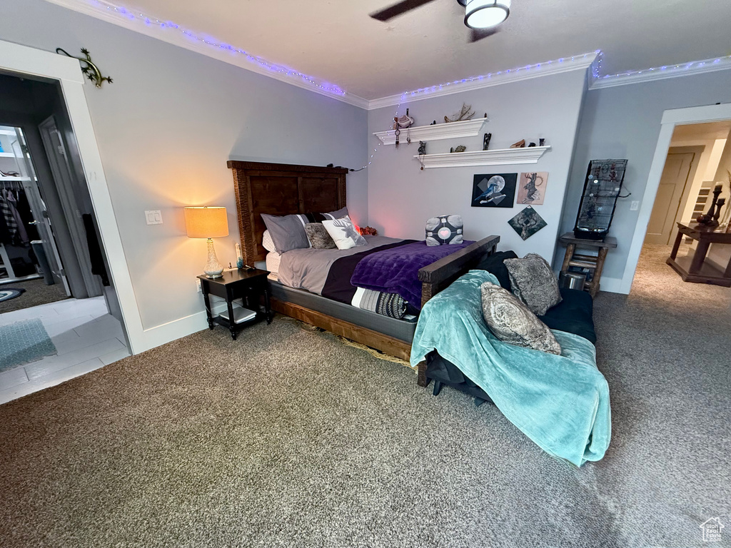 Bedroom with crown molding, carpet flooring, and baseboards