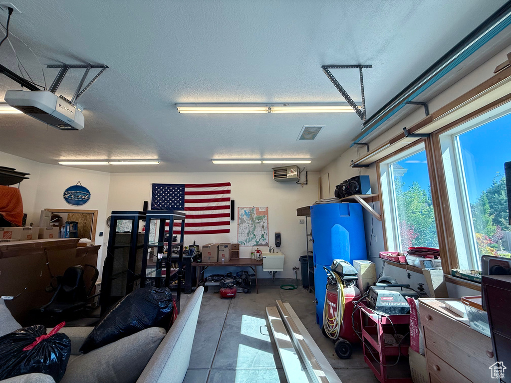 Garage with a garage door opener and a sink
