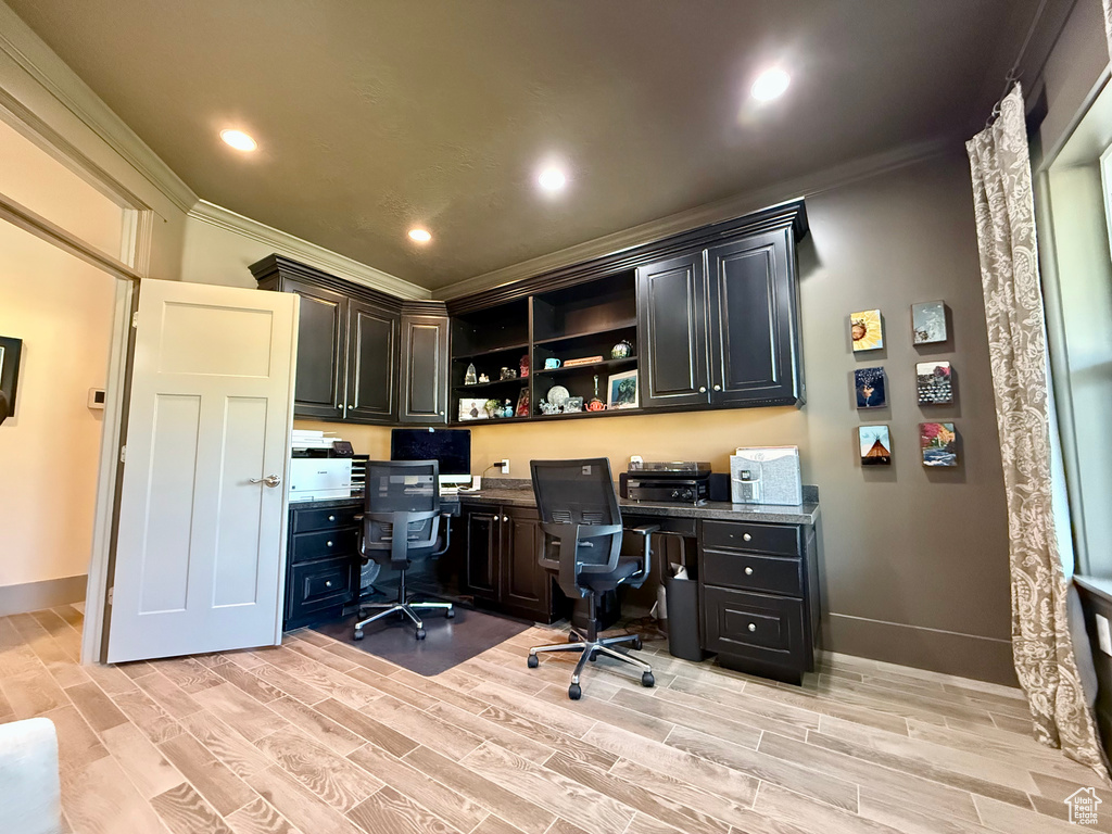 Office area with crown molding, built in study area, light wood-style flooring, baseboards, and recessed lighting