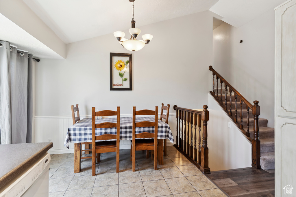 Dining area with lofted ceiling and a chandelier