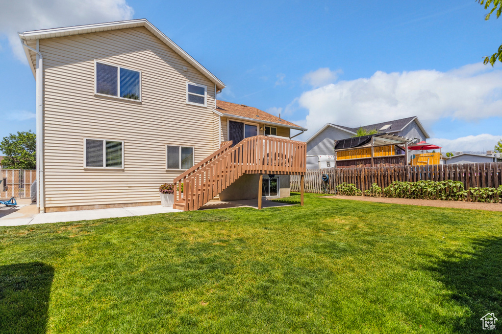 Rear view of property with stairway, a deck, and a patio