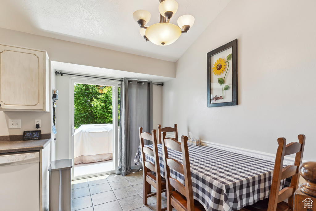 Dining space with a chandelier and light tile patterned flooring